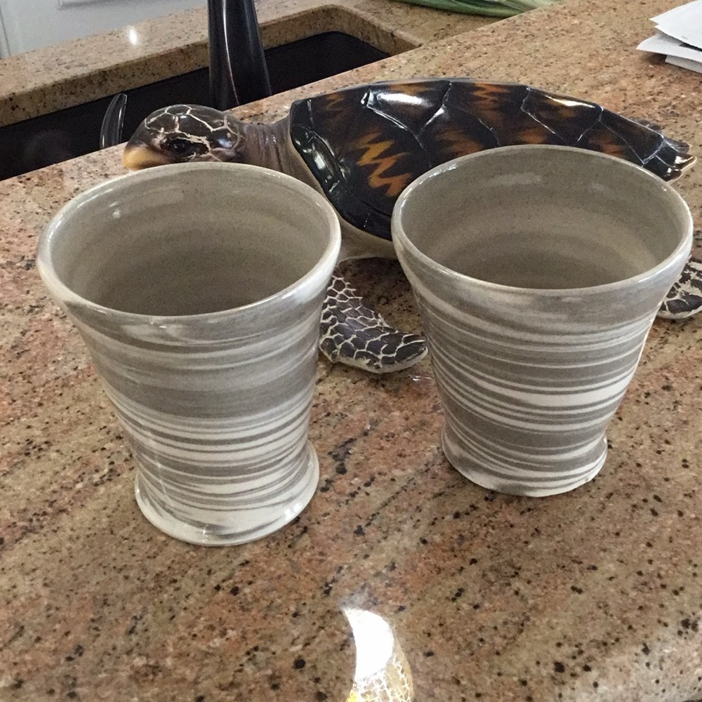 Two handmade pottery vases or mugs.